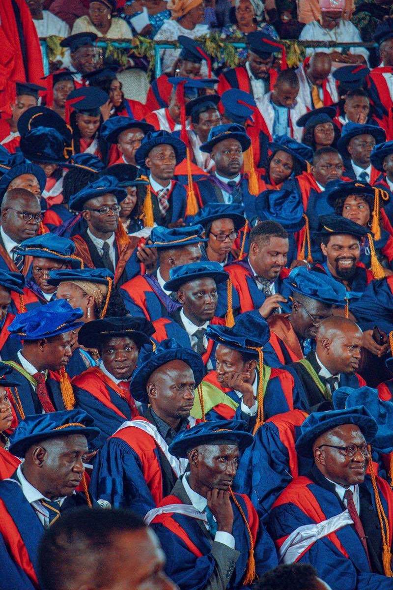 A large, colorful gathering at a university ceremony