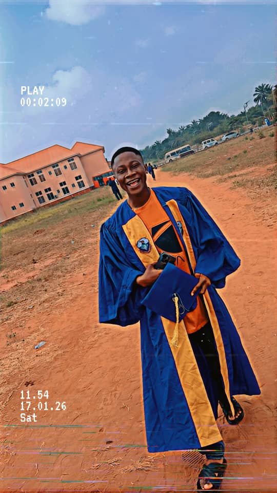 Emmanuel Friday Nweke smiling in his academic gown on his university campus